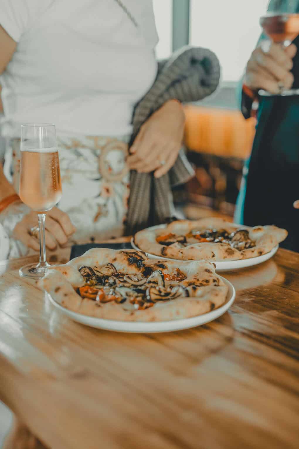 Two Neapolitan pizzas on a table at the Dachstuuv event space in the John & Will hotel with in-house pizza oven
