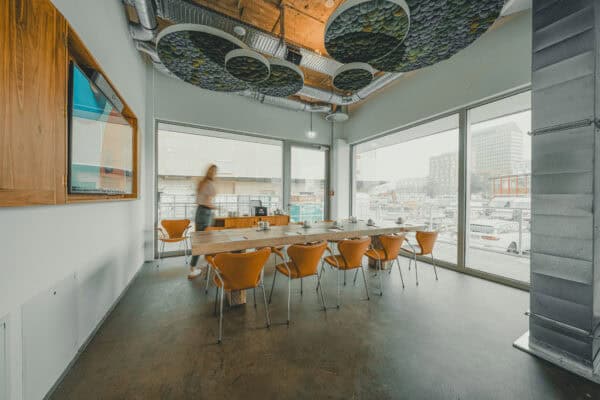 Compact conference room with screen and flexible seating at John & Will Bremen, located on the ground floor