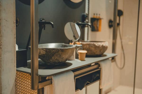 Detail of a stone sink in the bathroom , eco-conscious and elegant interior at John & Will Bremen