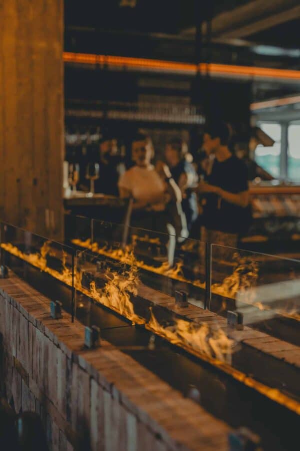 John & Will Silo Hotel Barception with ecological fireplace and warm evening vibe