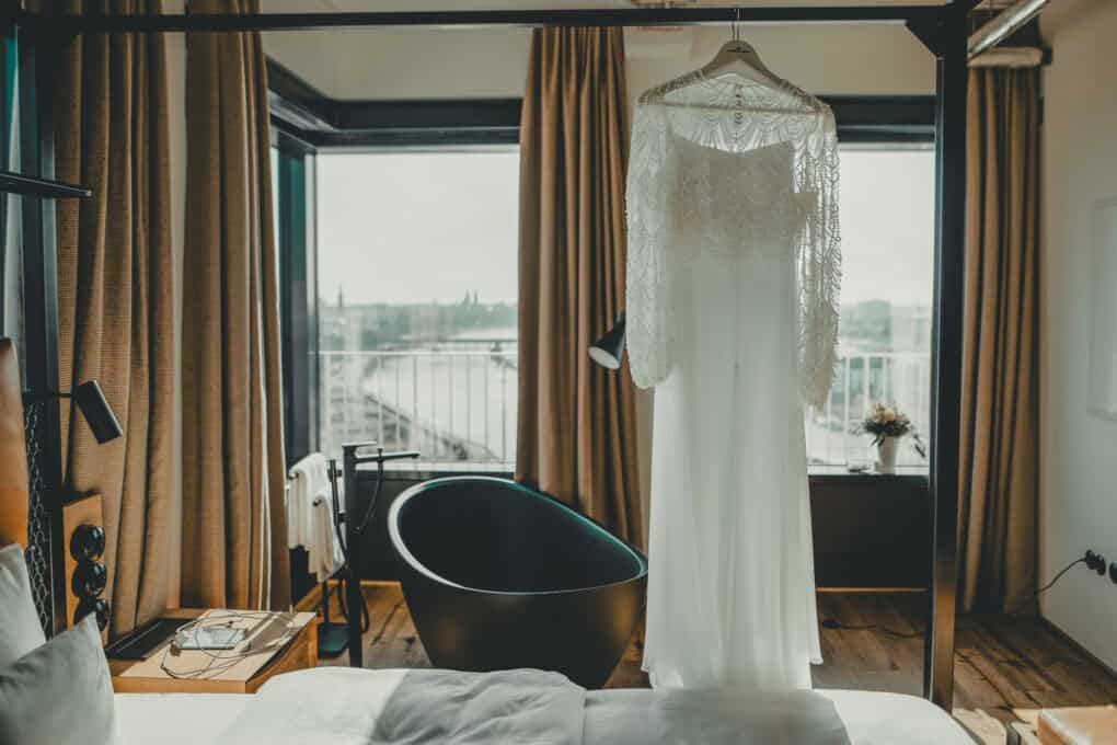 Brautkleid auf einem Bügel in der Toorn Stuuv – in einer romantischen Suite mit freistehender Badewanne und Blick über Bremen für die Hochzeitsnacht